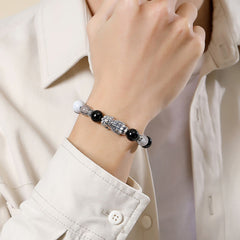 Black Obsidian Pi Xiu Bracelet – Worn on woman's wrist with white shirt, adjustable black cord, wealth bracelet