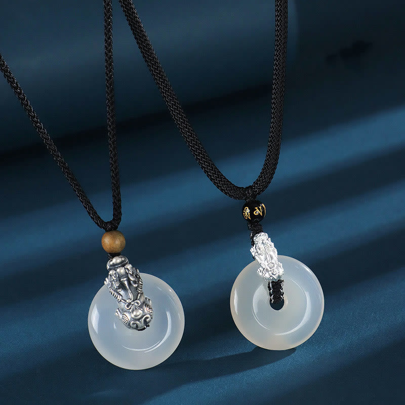 White Agate Peace Buckle Pi Xiu Silver Pendant – Two white agate pendants with silver PiXiu on blue fabric couple set
