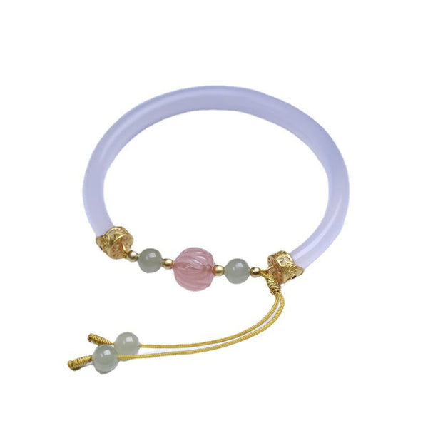 White Agate Lotus Hetian Jade Bracelet – full view of adjustable gold cord & jade bangle, elegant