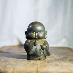 Little Monk Iron Powder Resin Statue – smiling child monk figurine, rust finish peace wisdom decor