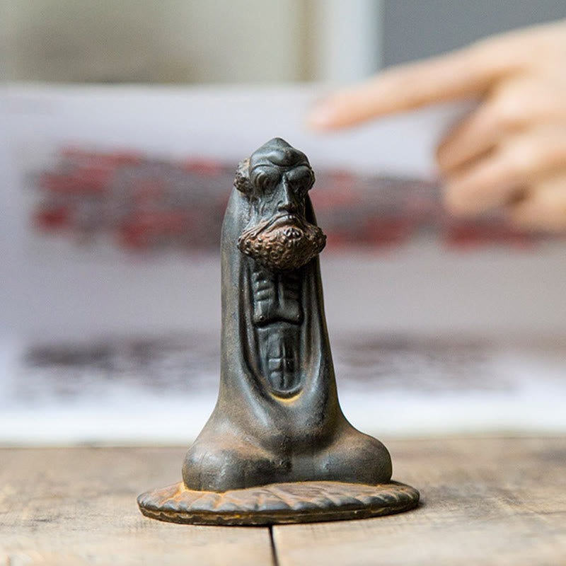 Bodhidharma Iron Powder Resin Statue – displayed on desk with laptop, office mindfulness reminder
