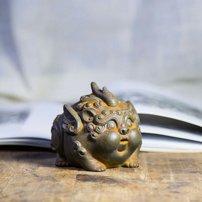 Handmade PiXiu Iron Powder Rust Cast Resin Wealth Statue – Rusted PiXiu in front of open book, scholarly zen home accent