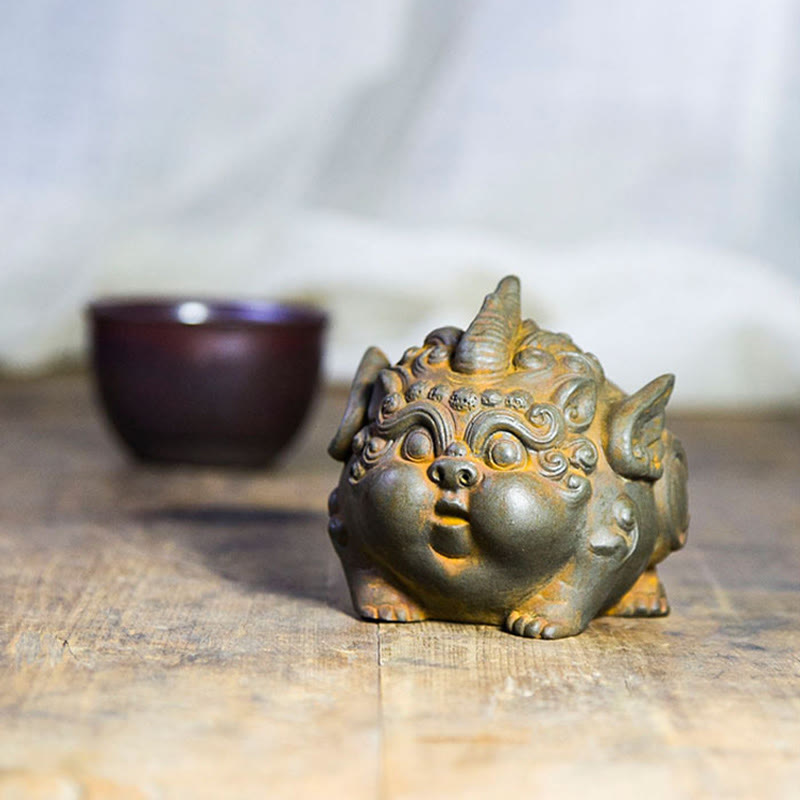 Handmade PiXiu Iron Powder Rust Cast Resin Wealth Statue – Rusted PiXiu with purple tea cup in background, tea table decor