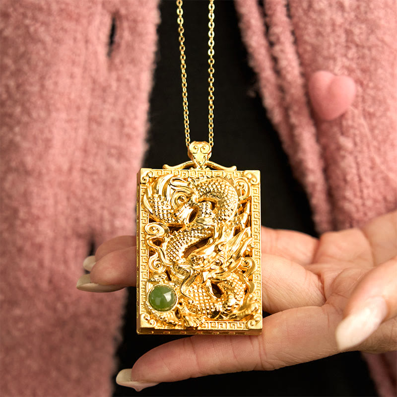 Dragon Hetian Jade Necklace | Strength – dragon pendant held between hands on pink fabric, protective