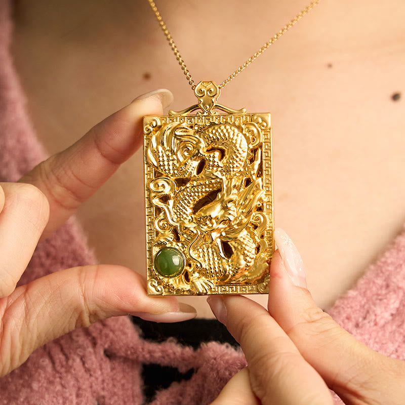 Dragon Hetian Jade Necklace | Strength – gold dragon plaque with jade cabochon held in two hands, confident