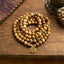 Mala Picture Jasper Lotus Bracelet - coiled on wood with fabric, grounding courage