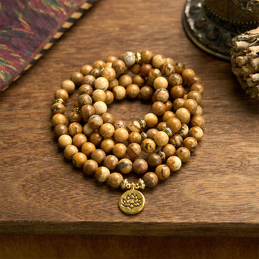 Mala Picture Jasper Lotus Bracelet - coiled on wood with fabric, grounding courage