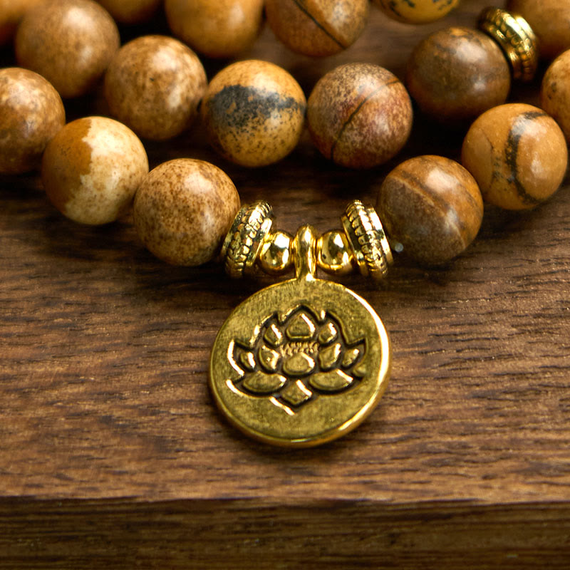 Mala Picture Jasper Lotus Bracelet - gold lotus charm detail on wood, courageous