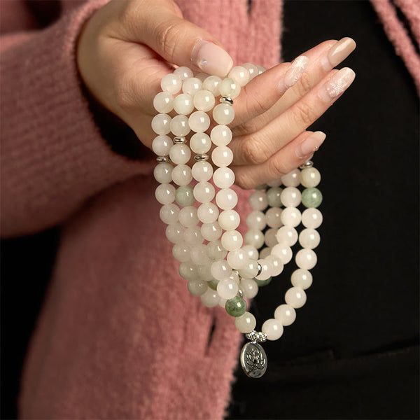108 Mala Tianshan Jade Lotus Bracelet - white jade strands held on wrist, lotus charm, mindful elegance
