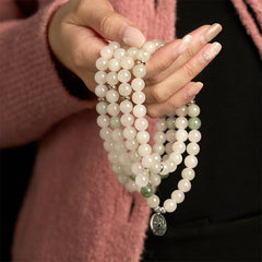 108 Mala Tianshan Jade Lotus Bracelet - white jade strands held on wrist, lotus charm, mindful elegance