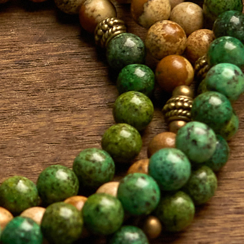 108 Mala Picture Jasper Turquoise Lotus Bracelet - stacked green and tan beads on dark wood, Stability