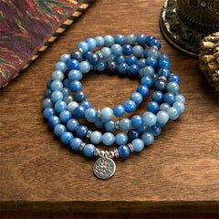 108 Mala Blue Aventurine Lotus Calm Bracelet – three-strand blue aventurine coils with silver lotus on wood, Focus