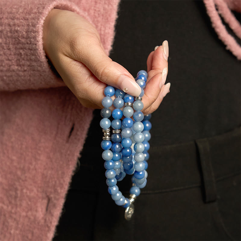 108 Mala Blue Aventurine Lotus Calm Bracelet – multi-strand blue beads with silver accents held in hand, Calm