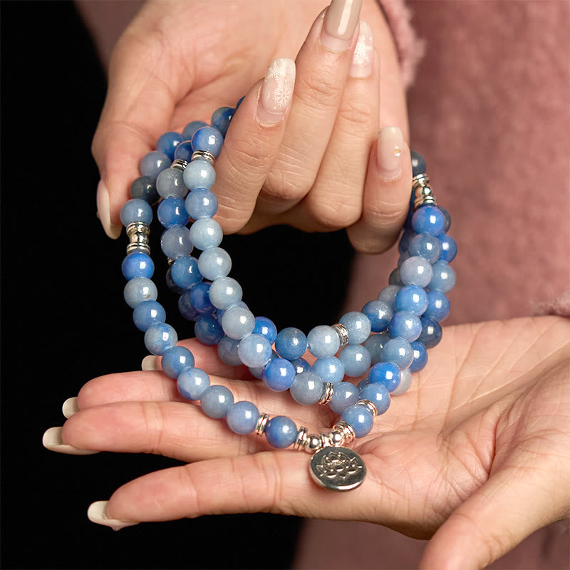 108 Mala Blue Aventurine Lotus Calm Bracelet – three-strand blue beads with silver lotus in cupped hands, Serene