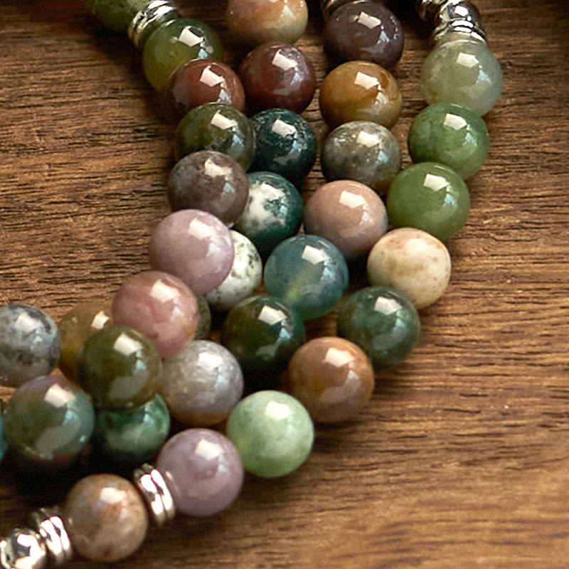 Indian Agate Lotus Mala Bracelet - beads close-up on wood, organic