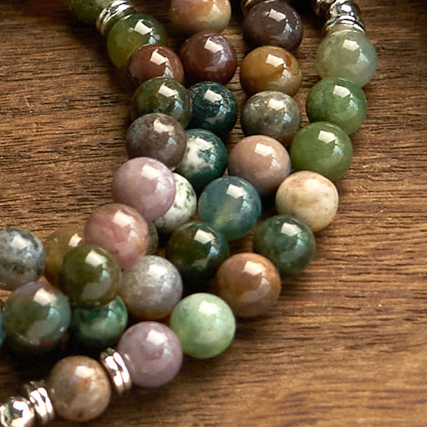 Indian Agate Lotus Mala Bracelet - beads close-up on wood, organic