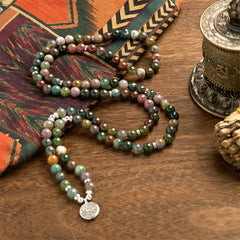 Indian Agate Lotus Mala Bracelet - mala necklace draped on wood, meditative