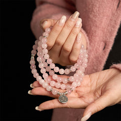 Rose Quartz Lotus Mala Bracelet - held in hands, soothing