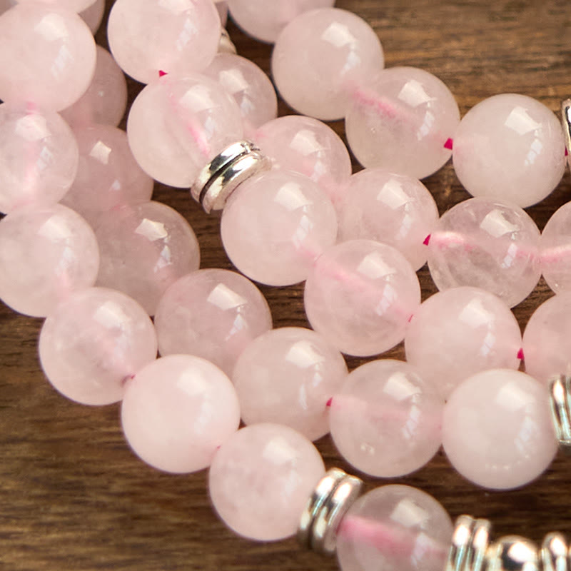 Rose Quartz Lotus Mala Bracelet - beads close-up on dark wood, healing