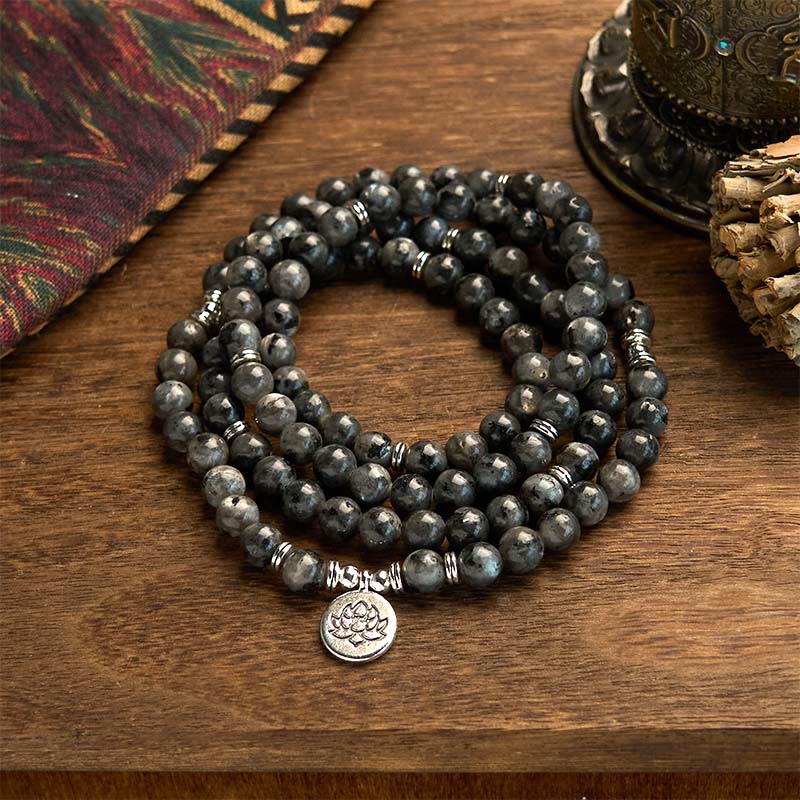 108 Mala Black Glitter Stone Lotus Bracelet - triple-strand black stone coils on wood, tribal textile, grounding