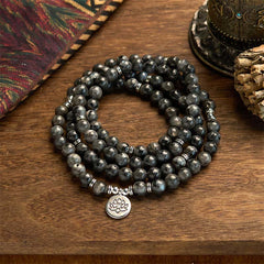 108 Mala Black Glitter Stone Lotus Bracelet - triple-strand black stone coils on wood, tribal textile, grounding