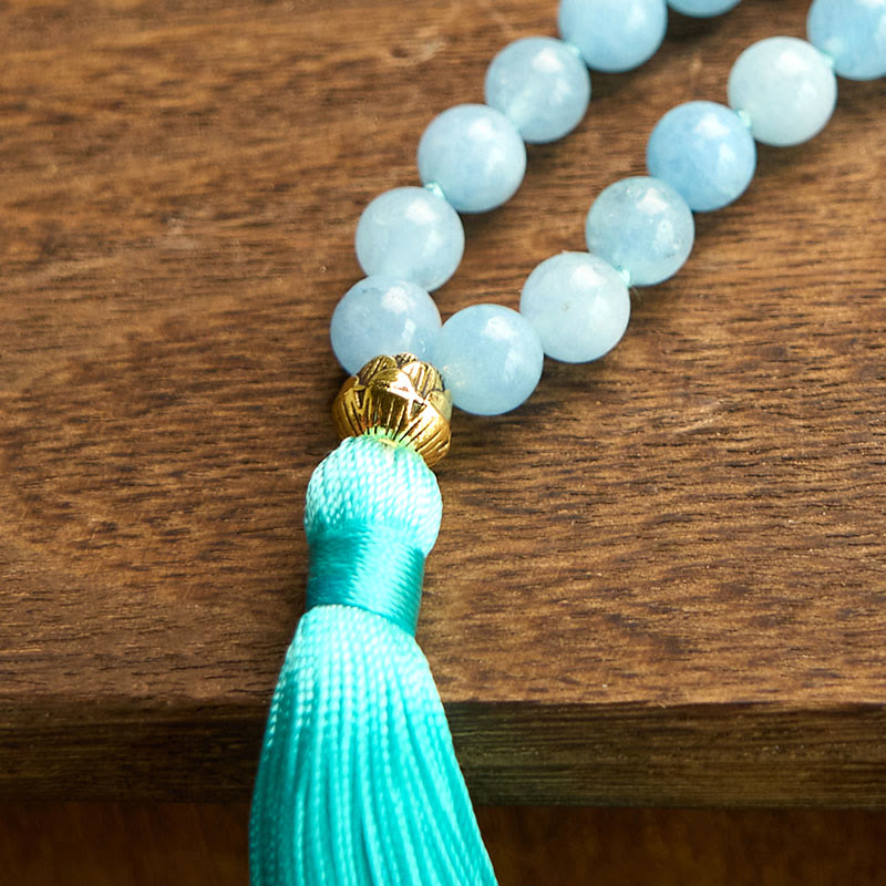 108 Mala Aquamarine Lotus Healing Bracelet – coiled loops of sky blue beads with lotus charm on minimalist wood, Peace