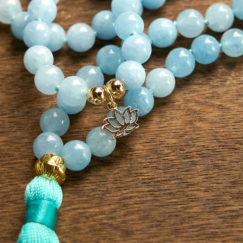 108 Mala Aquamarine Lotus Healing Bracelet – diagonal strand of aquamarine beads with lotus detail and teal tassel, Healing