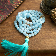 108 Mala Aquamarine Lotus Healing Bracelet – coiled aquamarine beads with turquoise silk tassel on wood, Peace