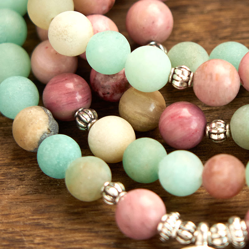 Mala Rhodonite Amazonite Lotus Bracelet - loose strands on wood, balancing elegance