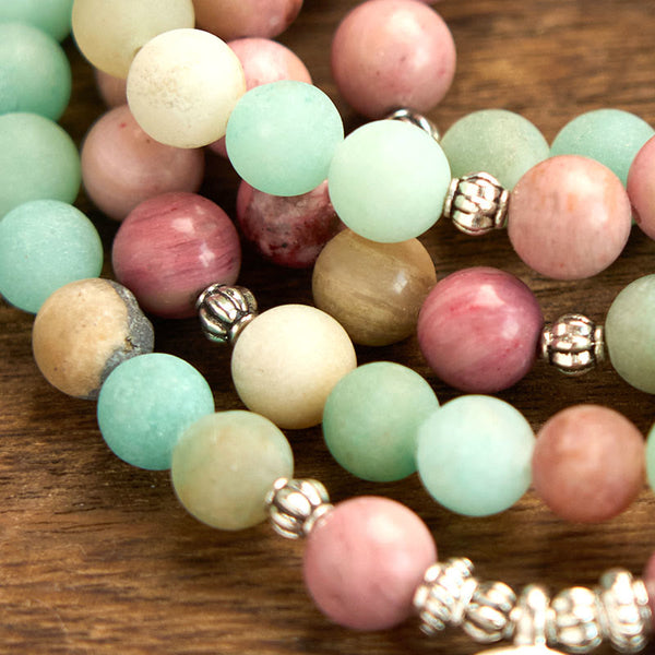 Mala Rhodonite Amazonite Lotus Bracelet - loose strands on wood, balancing elegance