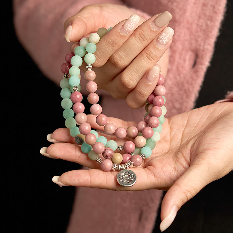 Mala Rhodonite Amazonite Lotus Bracelet - hands cradling strands, serene love