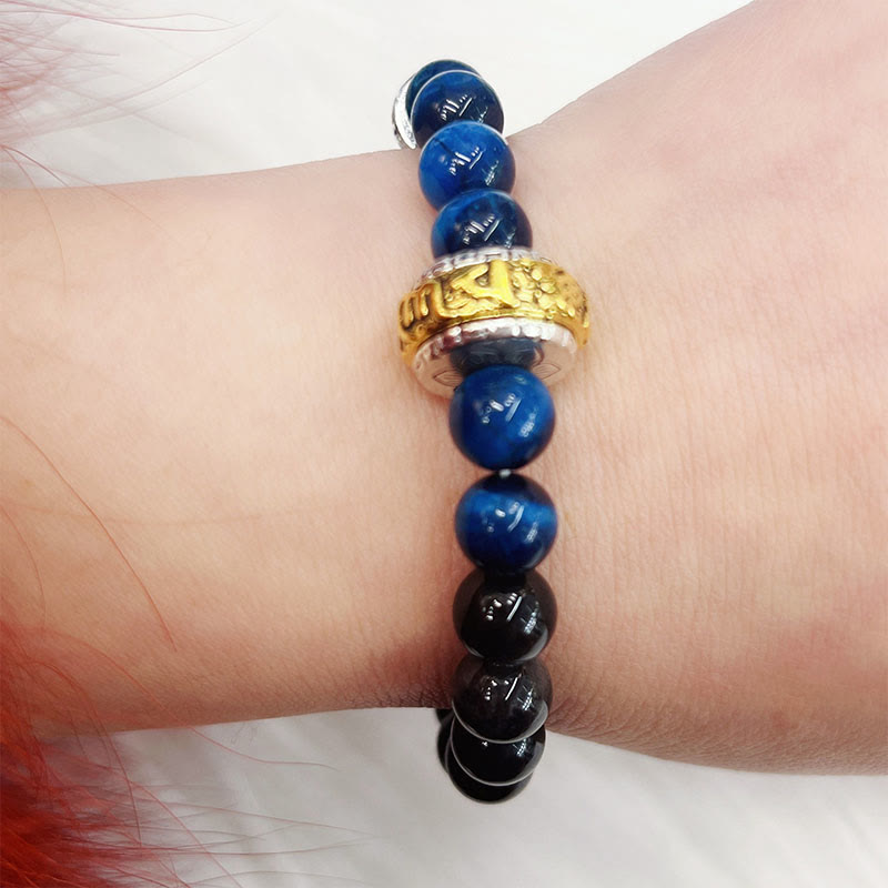 Om Mani Padme Hum Bracelet - Blue and black beads with gold metal charm on wrist, spiritual bead bracelet