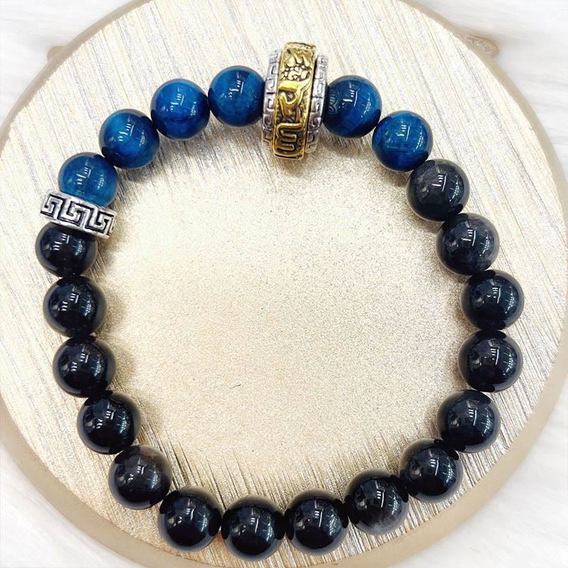 Om Mani Padme Hum Bracelet - Circular flat lay showing blue and black beads with gold spacer, mens jewelry