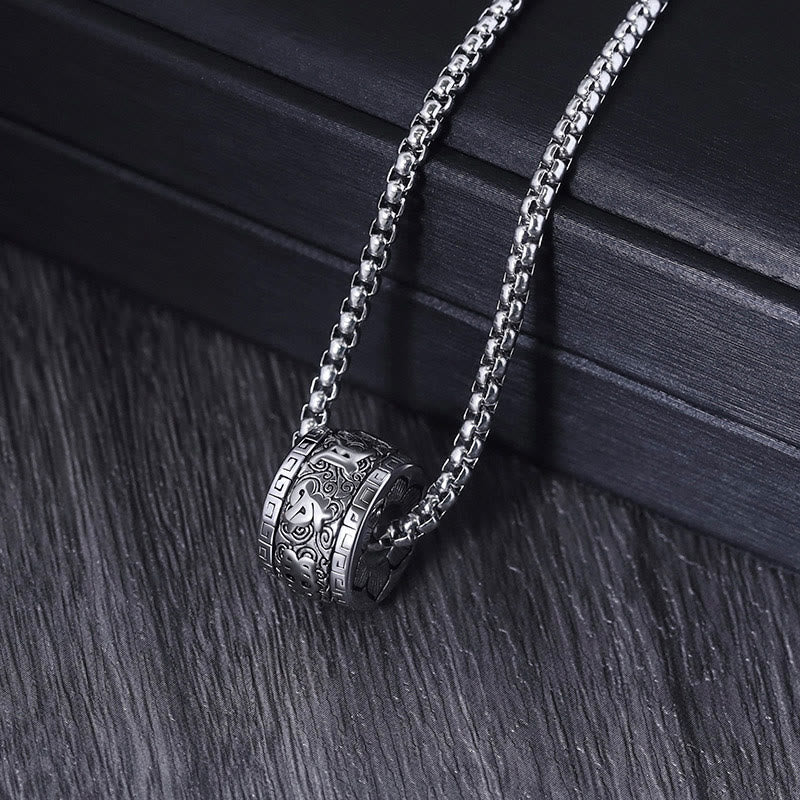 Om Mani Padme Hum Necklace – angled on dark wood, Tibetan mantra pendant