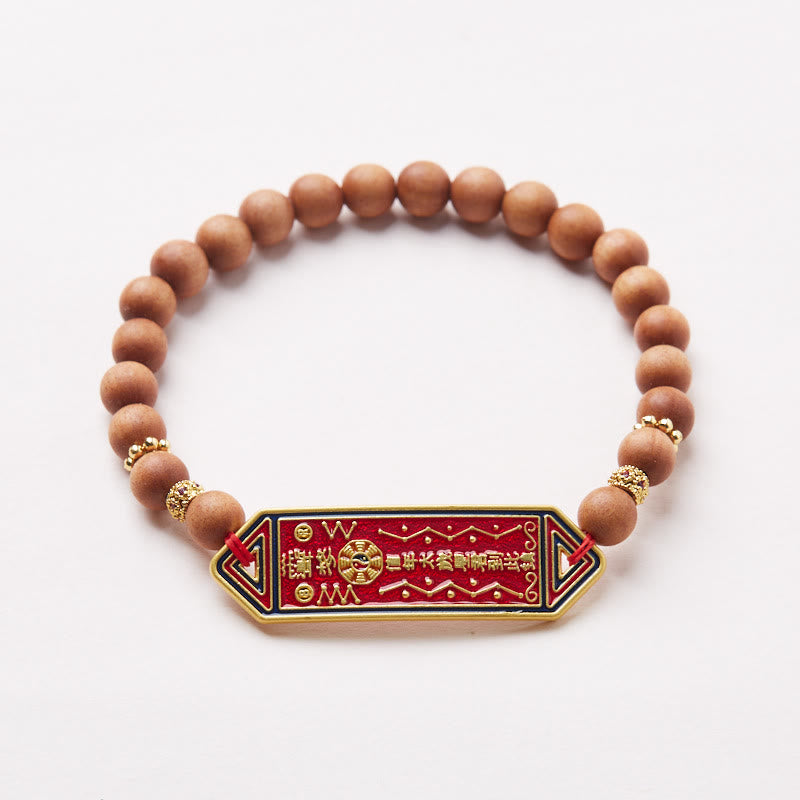 Sandalwood Bead Bagua Yin Yang Bracelet - overhead white studio shot showing gold spacer beads and red pendant, healing be...