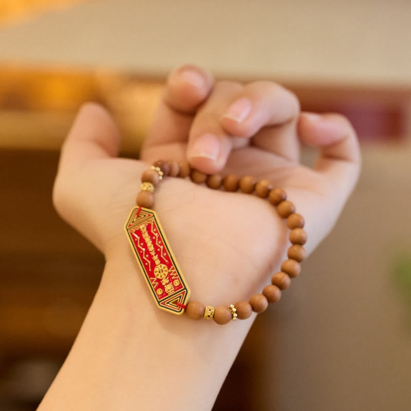 Sandalwood Bead Bagua Yin Yang Bracelet - worn on wrist showing sandalwood beads and red gold charm, harmony jewelry