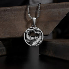 Pure Tin Double Koi Fish Wealth Pendant – circular koi pendant with chain draped on weathered metal block, rustic display