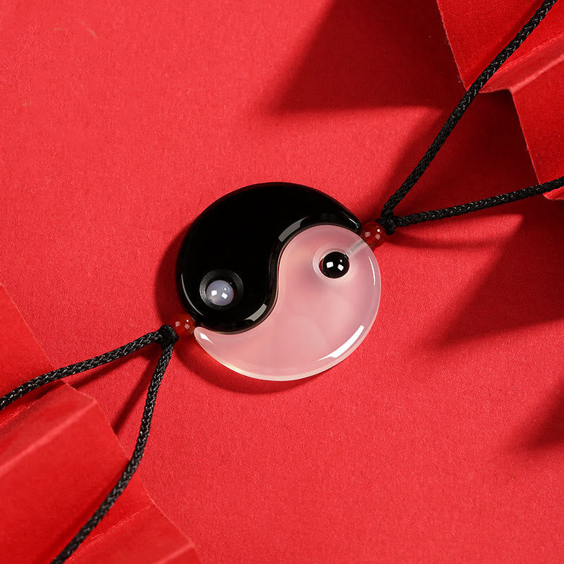Black Onyx White Agate Yin Yang Necklace - Complete yin-yang pendant showing glossy black obsidian and translucent white a...