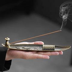 Koi Fish Boat Incense Burner - bronze boat with fisherman figure and incense smoke, held in hand, metalwork