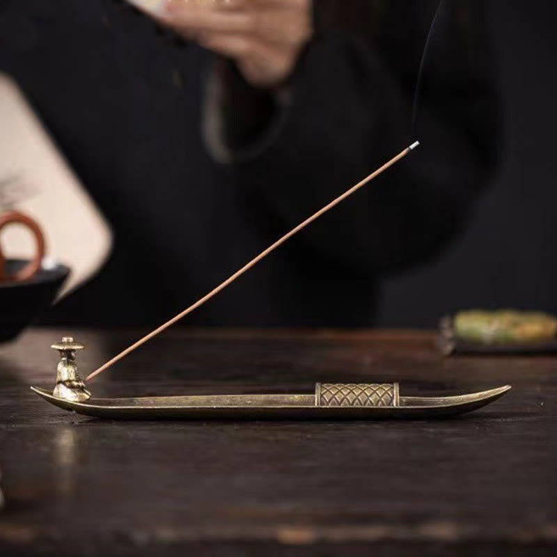 Koi Fish Boat Incense Burner - three-quarter elevated view, fisherman, fish reliefs, burning incense, wood