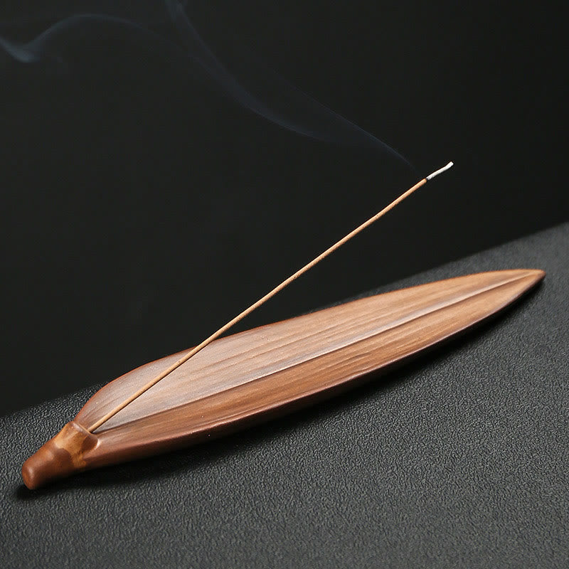 Buddha Hand Lotus Ceramic Incense Burner – placed on wooden table with burning incense, calming scene