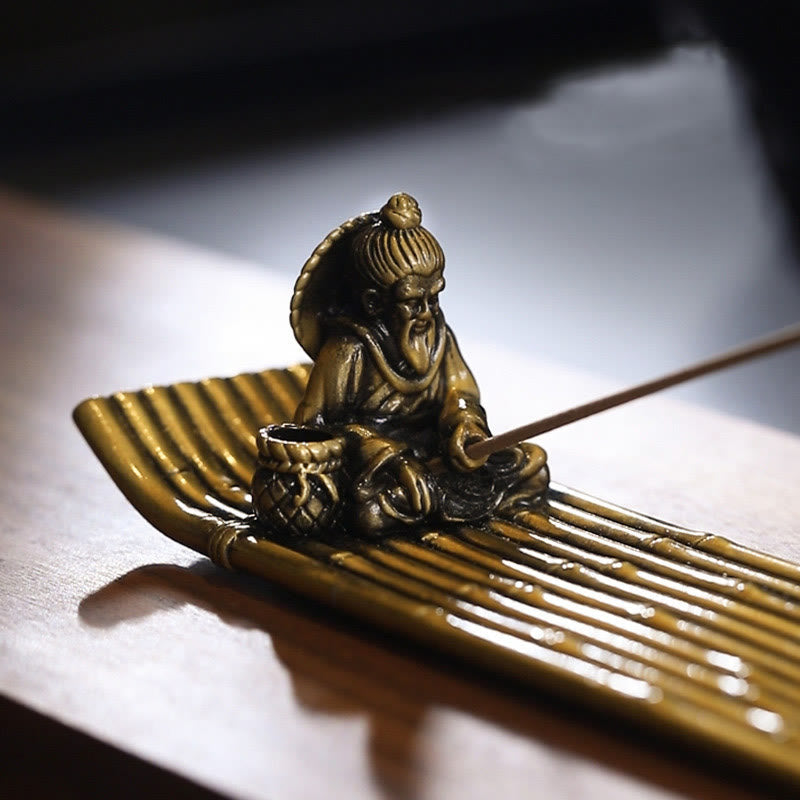 Bamboo Fishing Boat Alloy Incense Burner – detailed fisherman portrait on bamboo raft, dramatic side lighting
