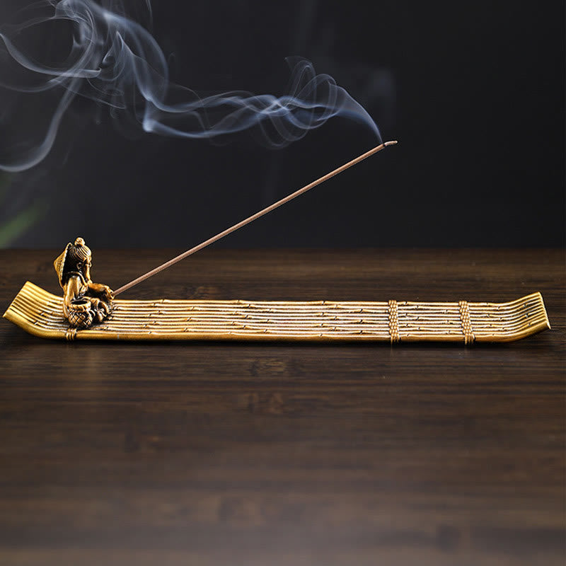 Bamboo Fishing Boat Alloy Incense Burner – side view brass raft with swirling smoke on dark wood, peaceful ambiance