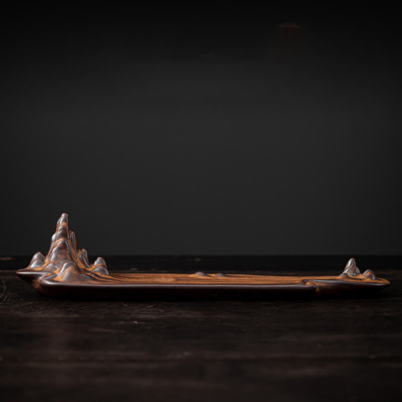 Mountains Boat Ceramic Incense Burner – low angle side view of brown mountain-shaped ceramic burner, dramatic lighting