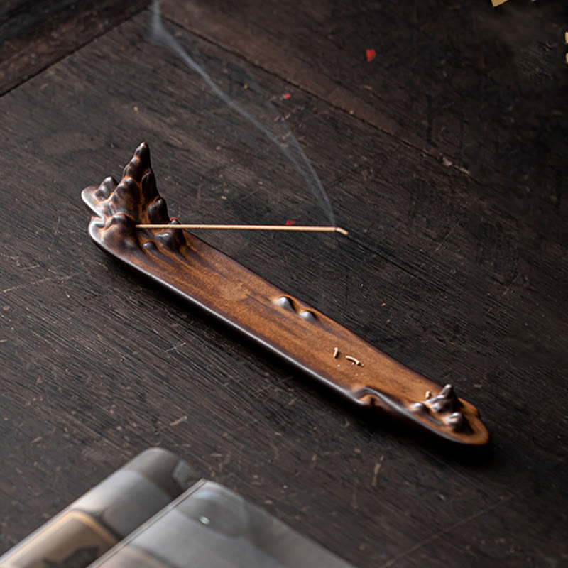 Mountains Boat Ceramic Incense Burner – top-down view of brown ceramic mountain burner with smoking incense on rustic wood
