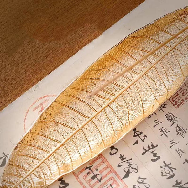 Oriental Leaf Alloy Incense Burner – gold leaf holder on calligraphy paper showing detailed vein texture, elegant decor