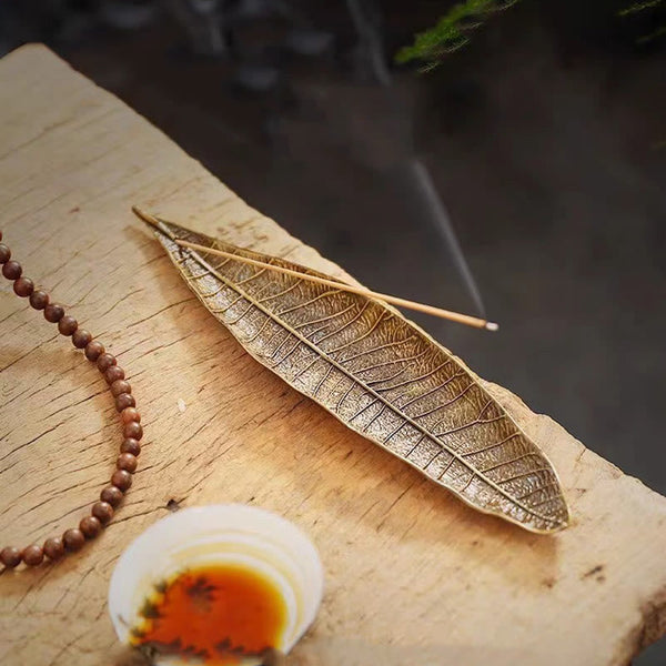 Oriental Leaf Alloy Incense Burner – reddish brown leaf holder with twin incense sticks and prayer beads, mindful ritual