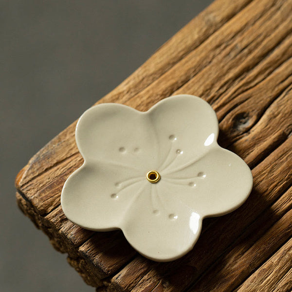Floral Lotus Ceramic Incense Burner - five-petal flower with charred incense, warm wood grain, zen