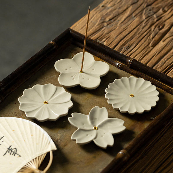 Floral Lotus Ceramic Incense Burner - four floral designs flat-lay on weathered wood, collection