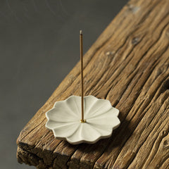 Floral Lotus Ceramic Incense Burner - cream petal dish with brass center on weathered wood, harmony